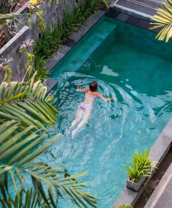 young-woman-swimming-in-the-pool-in-ubud-bali-vi-2022-07-11-03-48-14-utc-1.jpg